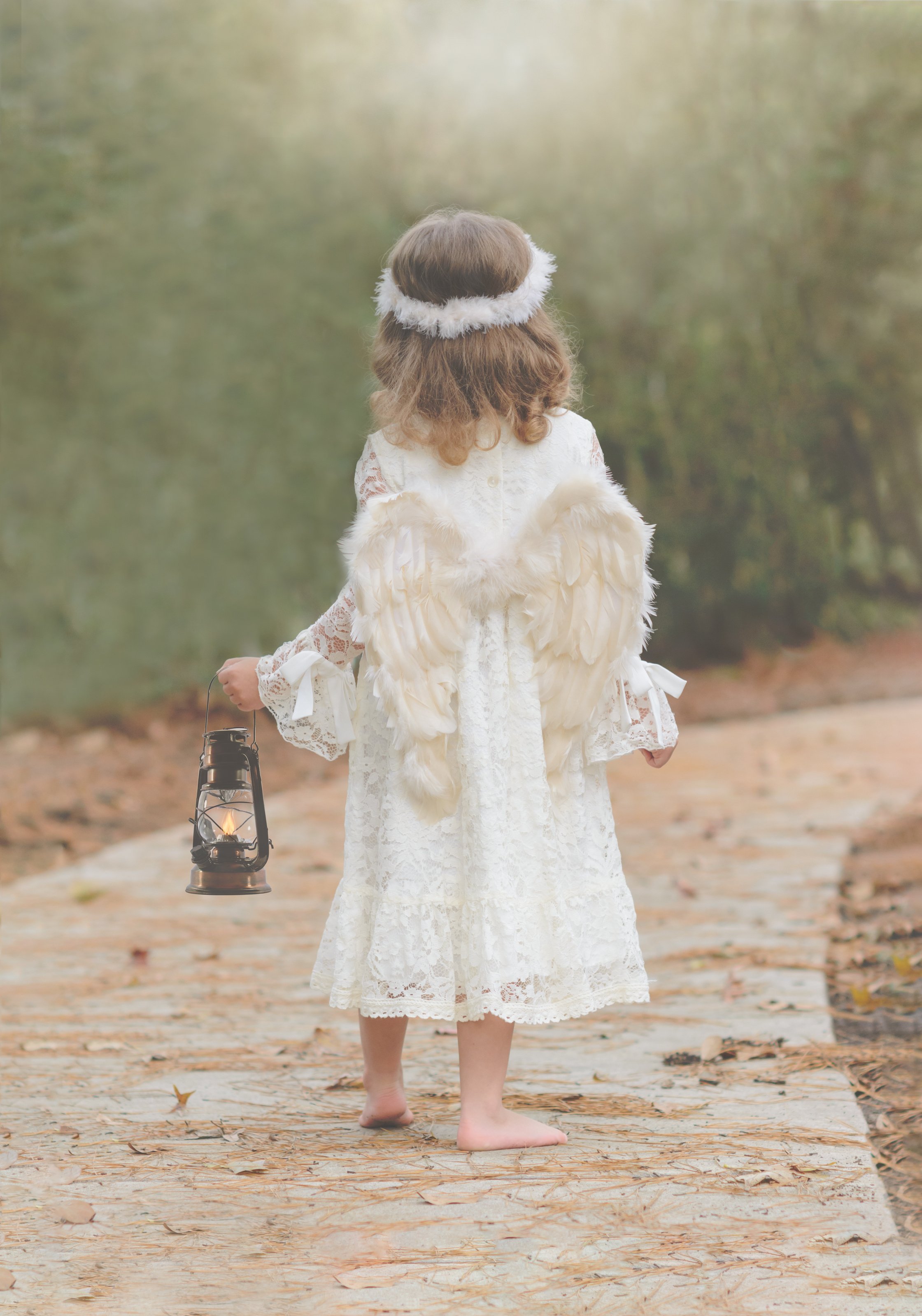 Little Angel Girl Holding a Lamp on the Road